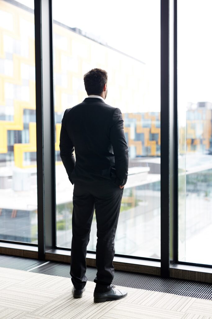 Pensive Businessman by Window