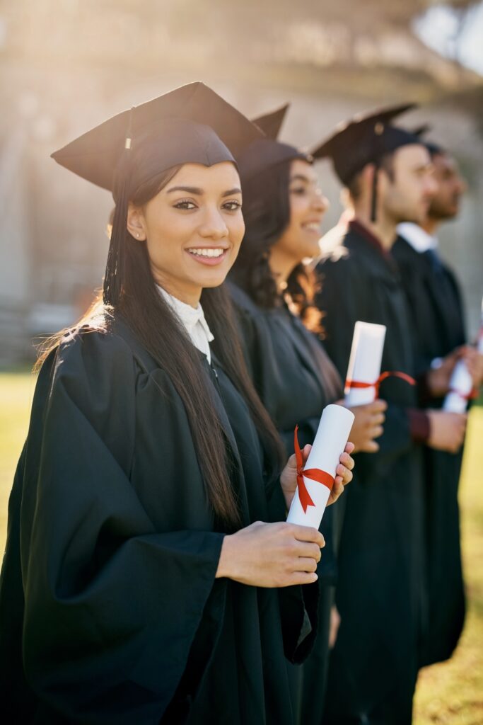 Shot of a group of students standing in a line on graduation day