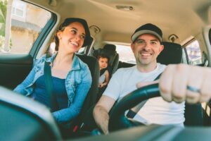 A happy family driving in the car.